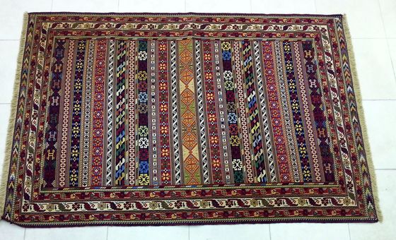 Flat-woven carpet with striped panels