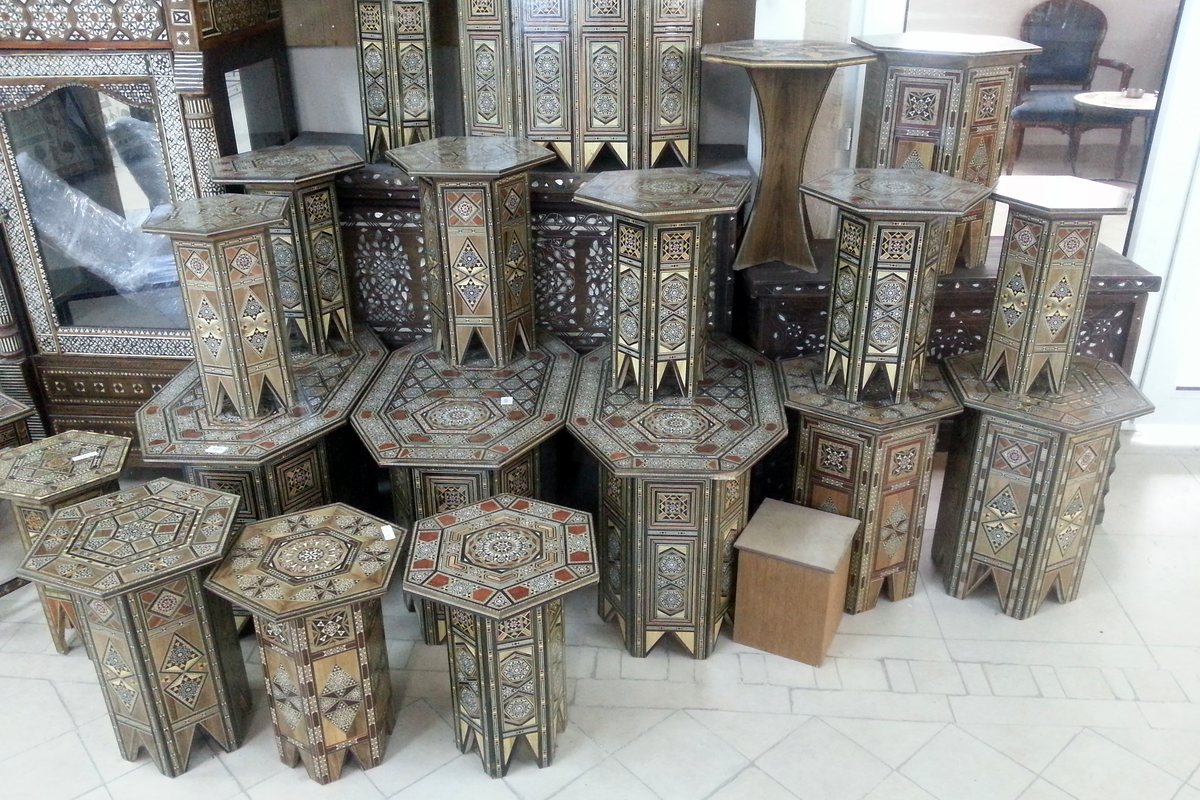 Inlaid side tables stacked in the gallery